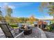 Stone patio with fire pit overlooking the lake, surrounded by mature trees and lush landscaping at 6316 Woodlake Dr, Buford, GA 30518