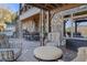 Covered patio with stone pillars, featuring outdoor seating, spiral staircase and a dining set at 6316 Woodlake Dr, Buford, GA 30518