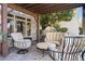 Comfortable patio seating area with plush striped chairs, an ottoman, and a tufted sofa under a wooden pergola at 6316 Woodlake Dr, Buford, GA 30518
