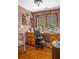 Charming sewing room featuring wooden cabinetry, a sewing machine, natural light, and hardwood floors at 6316 Woodlake Dr, Buford, GA 30518