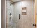 Step into luxury with this tiled walk-in shower featuring a built-in niche for toiletries at 6316 Woodlake Dr, Buford, GA 30518