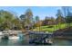 Lakefront home with private docks, boat lifts, and a manicured lawn at 6316 Woodlake Dr, Buford, GA 30518