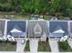 Aerial shot of townhomes featuring well-maintained lawns, backyards, and a central gazebo at 319 Riverton Way, Woodstock, GA 30188