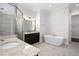 Bright bathroom with a glass shower, soaking tub, dual vanity, and tile floors at 319 Riverton Way, Woodstock, GA 30188