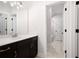 Modern bathroom features marble countertop, dark cabinets, tile floor, and tub with shower at 319 Riverton Way, Woodstock, GA 30188