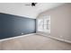 Bedroom with a blue accent wall, window with blinds, ceiling fan and carpeted floors at 319 Riverton Way, Woodstock, GA 30188