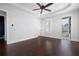 Spacious bedroom featuring hardwood floors, ceiling fan, tray ceiling, and natural light at 319 Riverton Way, Woodstock, GA 30188