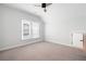 Bedroom with a sloped ceiling, large window with blinds, and gray carpeting at 319 Riverton Way, Woodstock, GA 30188