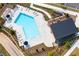 Aerial view of the community pool with lounge chairs, a covered deck, and lush landscaping at 319 Riverton Way, Woodstock, GA 30188