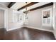 Dining room featuring hardwood floors, wood beam ceiling, and many windows with shutter blinds at 319 Riverton Way, Woodstock, GA 30188