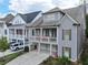 This home has a double porch, neutral siding, well-maintained landscaping, and an inviting entrance at 319 Riverton Way, Woodstock, GA 30188