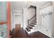Elegant foyer featuring hardwood floors, a staircase, and built-in storage, creating a welcoming entry at 319 Riverton Way, Woodstock, GA 30188