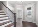 Inviting foyer with hardwood floors, a staircase and a charming doorway at 319 Riverton Way, Woodstock, GA 30188
