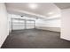 Spacious two car garage with dark floors and white walls and garage doors at 319 Riverton Way, Woodstock, GA 30188