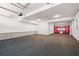 Spacious two car garage with dark floors and white walls and bright red storage at 319 Riverton Way, Woodstock, GA 30188
