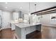 Modern kitchen featuring white cabinetry, quartz countertops, a central island, and stainless steel appliances at 319 Riverton Way, Woodstock, GA 30188