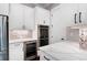 Elegant kitchen with stainless steel appliances and custom cabinetry with stylish countertops and tiled backsplash at 319 Riverton Way, Woodstock, GA 30188