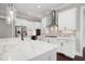 Well-equipped kitchen featuring modern appliances, a stylish backsplash, quartz counters and custom cabinetry at 319 Riverton Way, Woodstock, GA 30188