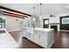Spacious open floor plan with a kitchen island, view to the living room, fireplace, and natural light at 319 Riverton Way, Woodstock, GA 30188