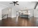 Open-concept living room flowing into the kitchen, highlighting the hardwood floors and natural light at 319 Riverton Way, Woodstock, GA 30188