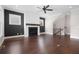 Spacious living room featuring a fireplace, hardwood floors, a ceiling fan and stairs to the second floor at 319 Riverton Way, Woodstock, GA 30188