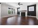 Bright living room featuring a modern fireplace, hardwood floors, and large windows providing ample natural light at 319 Riverton Way, Woodstock, GA 30188