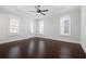 Primary bedroom with hardwood floors, high ceilings, patterned wallpaper, and natural light at 319 Riverton Way, Woodstock, GA 30188