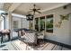 Inviting outdoor seating area with a ceiling fan, grill, outdoor television, and decorative accents at 319 Riverton Way, Woodstock, GA 30188