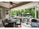 Inviting outdoor seating area with a ceiling fan, grill, and views of the backyard pool and landscaping at 319 Riverton Way, Woodstock, GA 30188