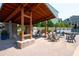 Inviting patio with chairs under wooden pergola featuring brick accents, ideal for outdoor gatherings at 319 Riverton Way, Woodstock, GA 30188