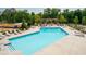 Sparkling pool offers a refreshing escape with numerous lounge chairs and a pergola at 319 Riverton Way, Woodstock, GA 30188
