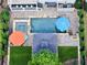Aerial view of a backyard oasis featuring a pool, spa, gazebo, patio, and meticulous landscaping at 319 Riverton Way, Woodstock, GA 30188