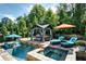 Backyard oasis featuring a pool, hot tub, and covered lounge area with stylish outdoor furniture at 319 Riverton Way, Woodstock, GA 30188