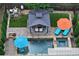 Aerial view of a backyard oasis featuring a pool, spa, gazebo, lounge chairs, and meticulous landscaping at 319 Riverton Way, Woodstock, GA 30188