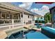 A luxurious in-ground pool with a tanning ledge, complemented by patio furniture, offers a refreshing outdoor oasis at 319 Riverton Way, Woodstock, GA 30188