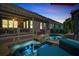 Outdoor living space with a pool and hot tub featuring lighting and a covered patio at 319 Riverton Way, Woodstock, GA 30188