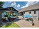 Backyard retreat featuring a pool, hot tub, gazebo with seating, and lush greenery at 319 Riverton Way, Woodstock, GA 30188