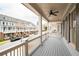 This is an image of the open-air porch with a ceiling fan and a view of the neighborhood at 319 Riverton Way, Woodstock, GA 30188