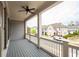 This is an image of the open-air porch, with a ceiling fan and view of neighboring homes at 319 Riverton Way, Woodstock, GA 30188