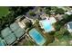 Aerial view featuring tennis courts, a community pool, clubhouse and parking area at 4710 Mcintosh Dr, Cumming, GA 30040