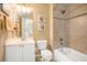 A full bathroom features a shower and tub combination, white cabinets, and a framed mirror at 4710 Mcintosh Dr, Cumming, GA 30040