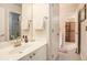 Bright bathroom with a white vanity, large mirror, and a view of the shower/tub combo at 4710 Mcintosh Dr, Cumming, GA 30040