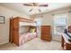 Cozy bedroom with a wooden bunk bed, large windows, and a dresser at 4710 Mcintosh Dr, Cumming, GA 30040