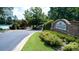Community entrance with stone signage, lush landscaping and well maintained grounds at 4710 Mcintosh Dr, Cumming, GA 30040