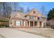 Beautiful brick home with mature trees, a manicured lawn, and a side-entry garage at 4710 Mcintosh Dr, Cumming, GA 30040