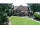Charming home with well-maintained lawn, stone accents, and a cozy front porch and deck at 4710 Mcintosh Dr, Cumming, GA 30040