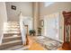 Light foyer with hardwood floors and staircase and a view of the front door at 4710 Mcintosh Dr, Cumming, GA 30040