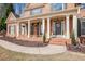 Inviting front porch with brick columns, manicured landscaping, and colorful flowers at 4710 Mcintosh Dr, Cumming, GA 30040