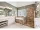 Modern main bathroom featuring a glass-enclosed shower, soaking tub, and double vanity at 4710 Mcintosh Dr, Cumming, GA 30040