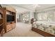 Bright main bedroom with a wooden cabinet, large windows, neutral carpet, and a ceiling fan at 4710 Mcintosh Dr, Cumming, GA 30040